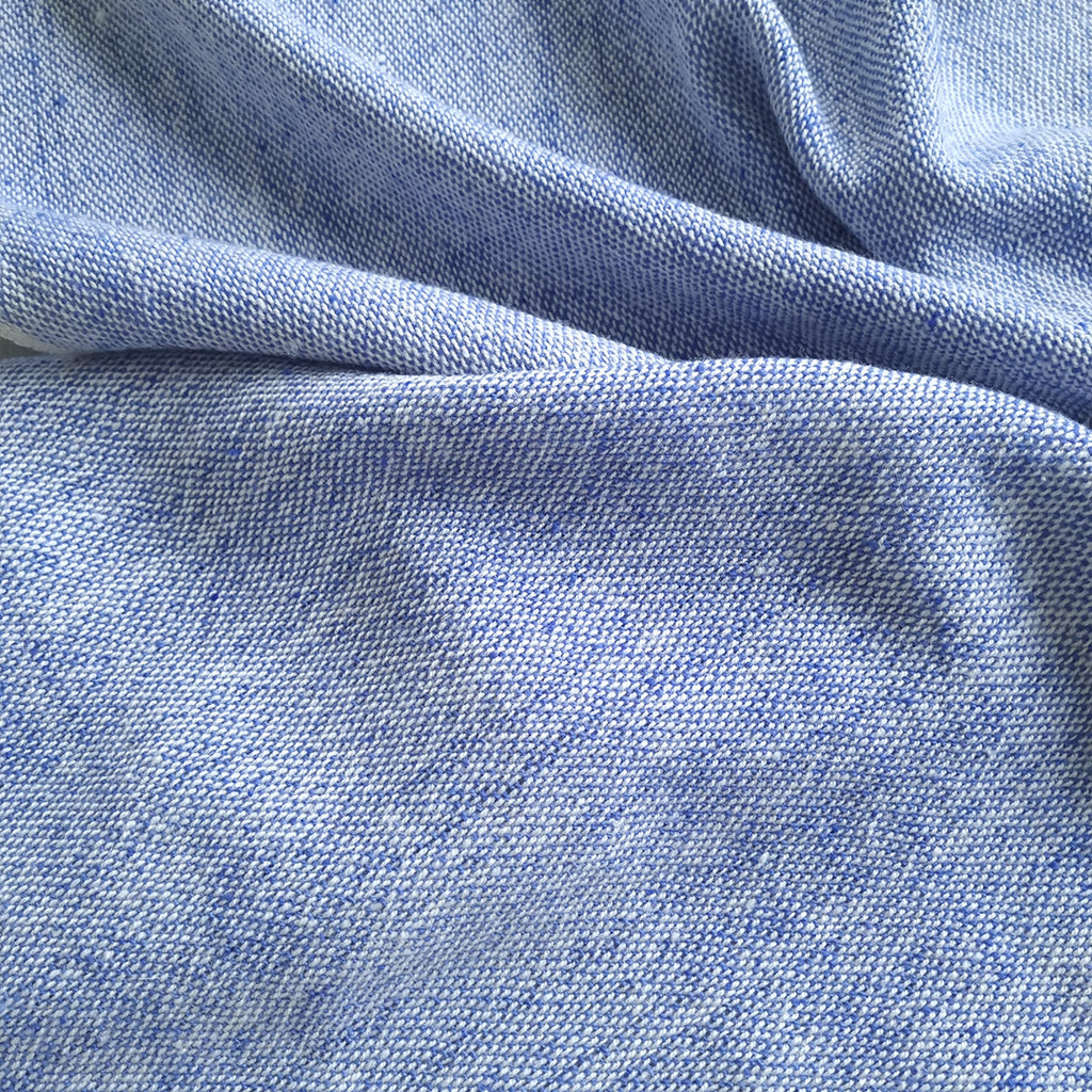 Cielo Sur shawl with sky blue melange and fringed finish