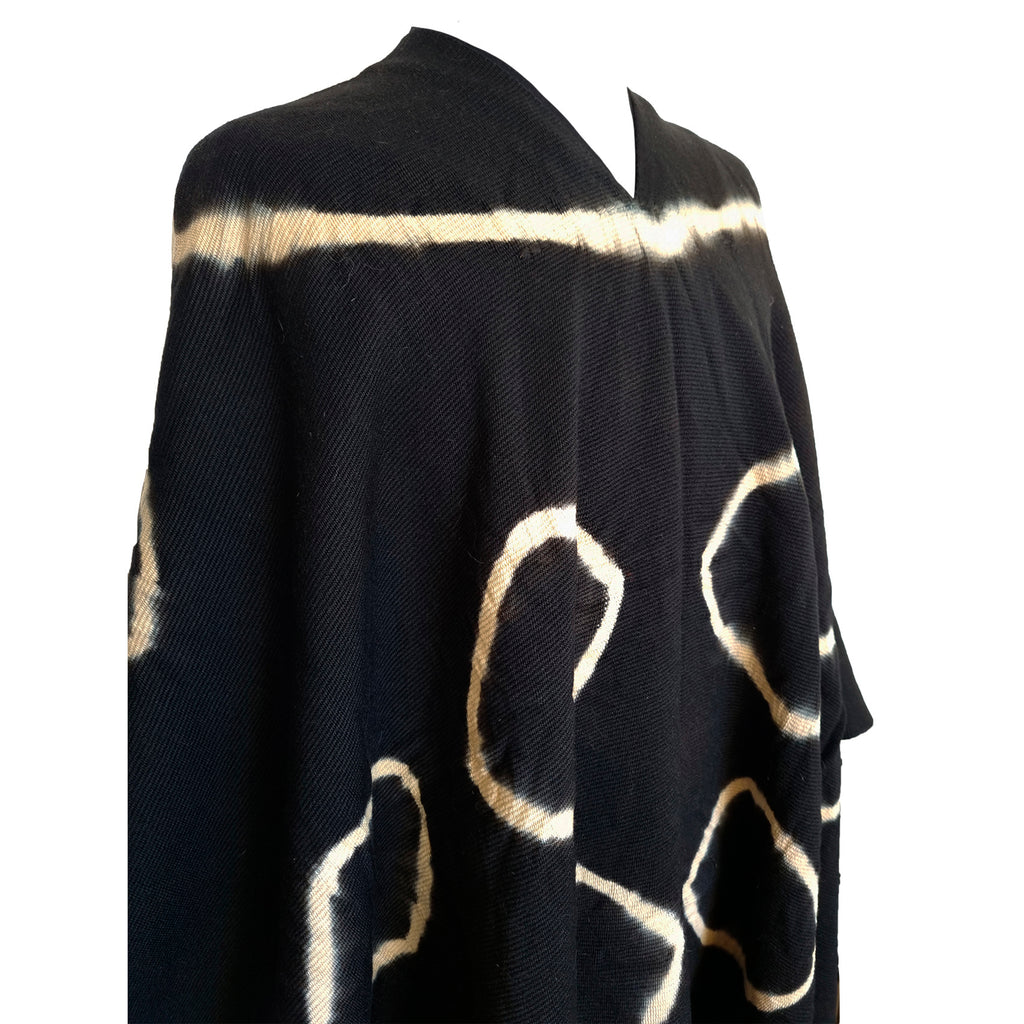 Close-up of Huinganco Argollas poncho with circular tie-dye wool motifs