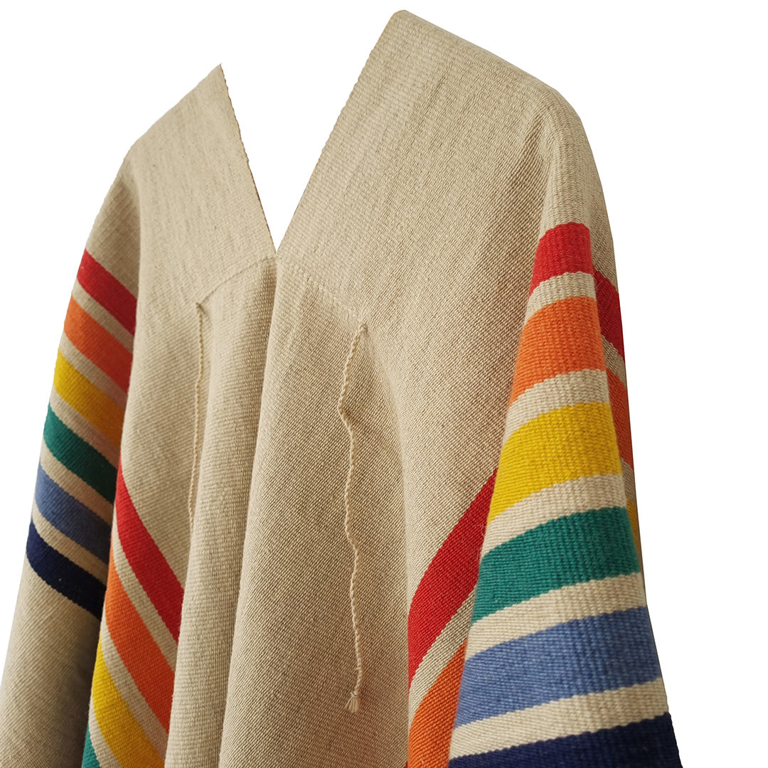 Close-up of Rainbow Tradition Poncho with colorful woven stripe detail