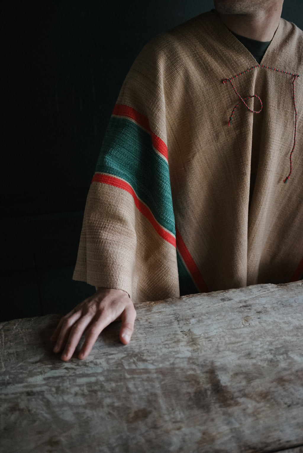 Close-up of Talamayo Listado poncho with green band and fine red stripes