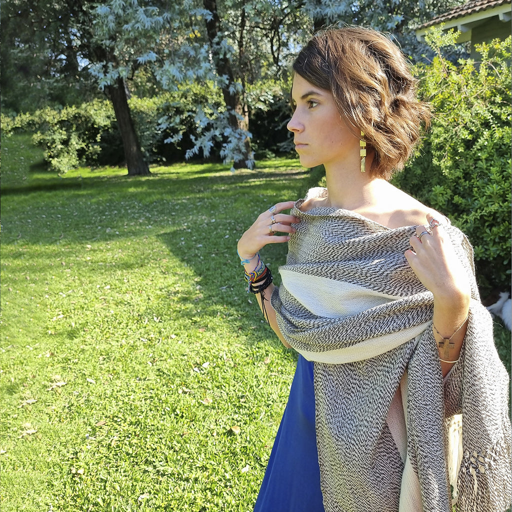 Earth tone wool wrap worn over the shoulders outdoors